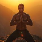 A-powerful-focused-man-standing-alone-at-sunrise-on-a-rugged-mountain-peak